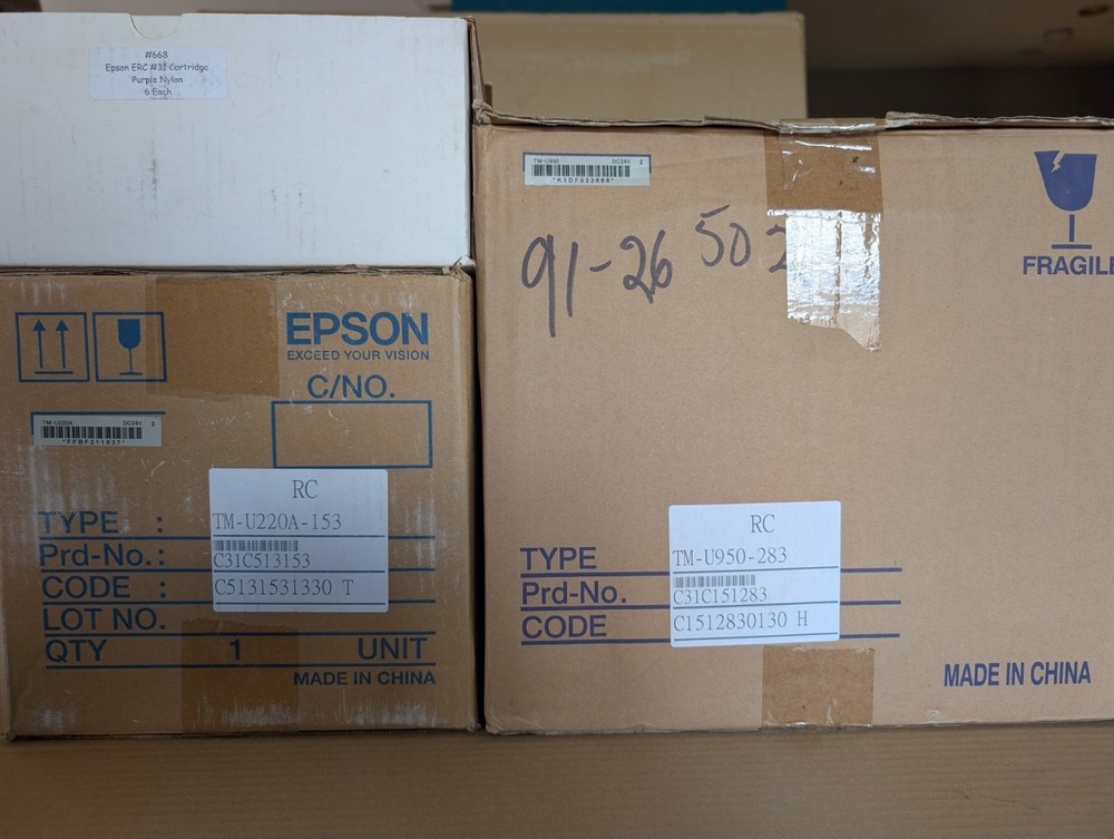 New Epson TMU950 and TMU220A receipt printers and box of TMU950 ribbons